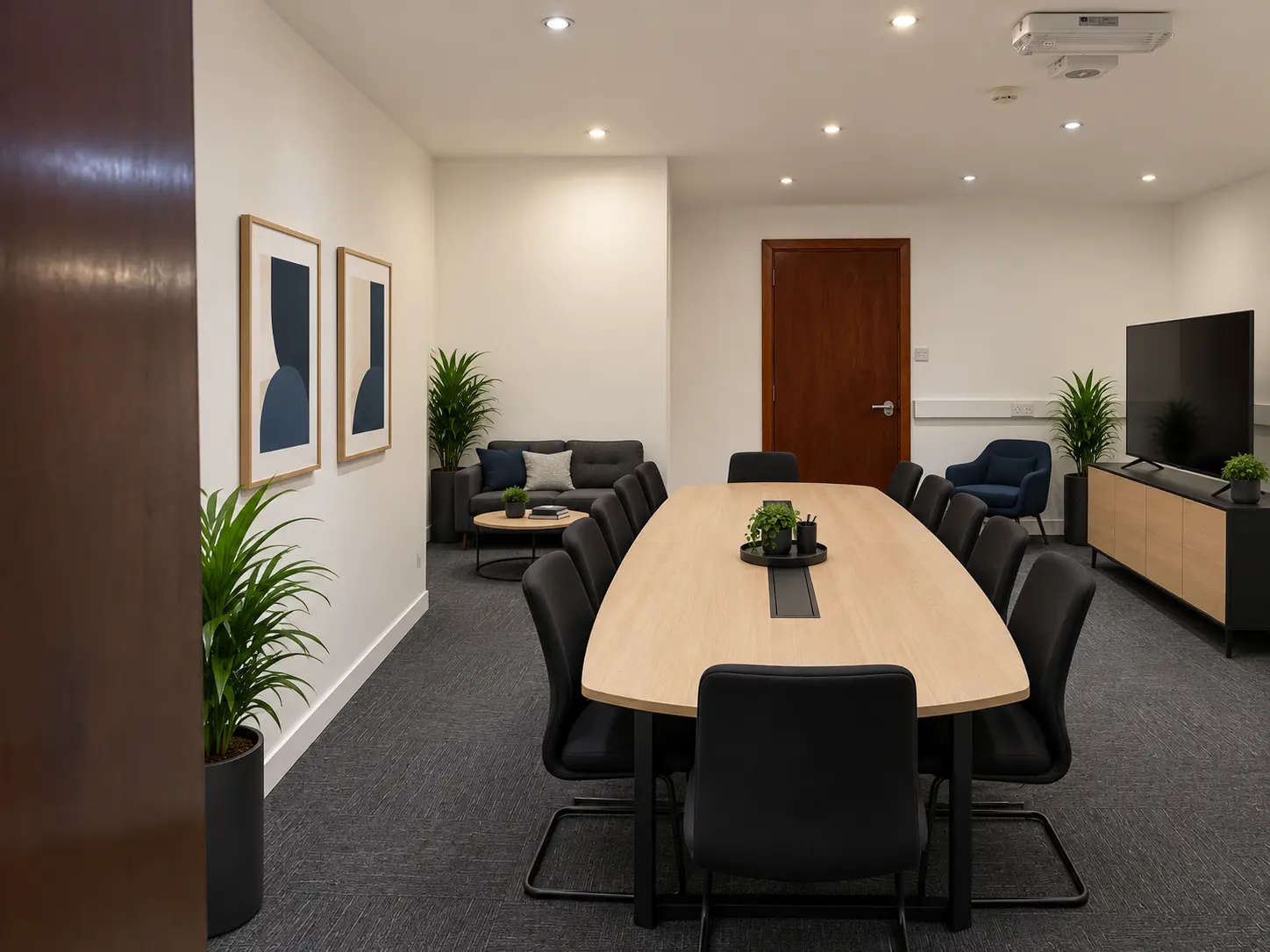 Twelve-seat boardroom with lounge area and presentation screen at River House