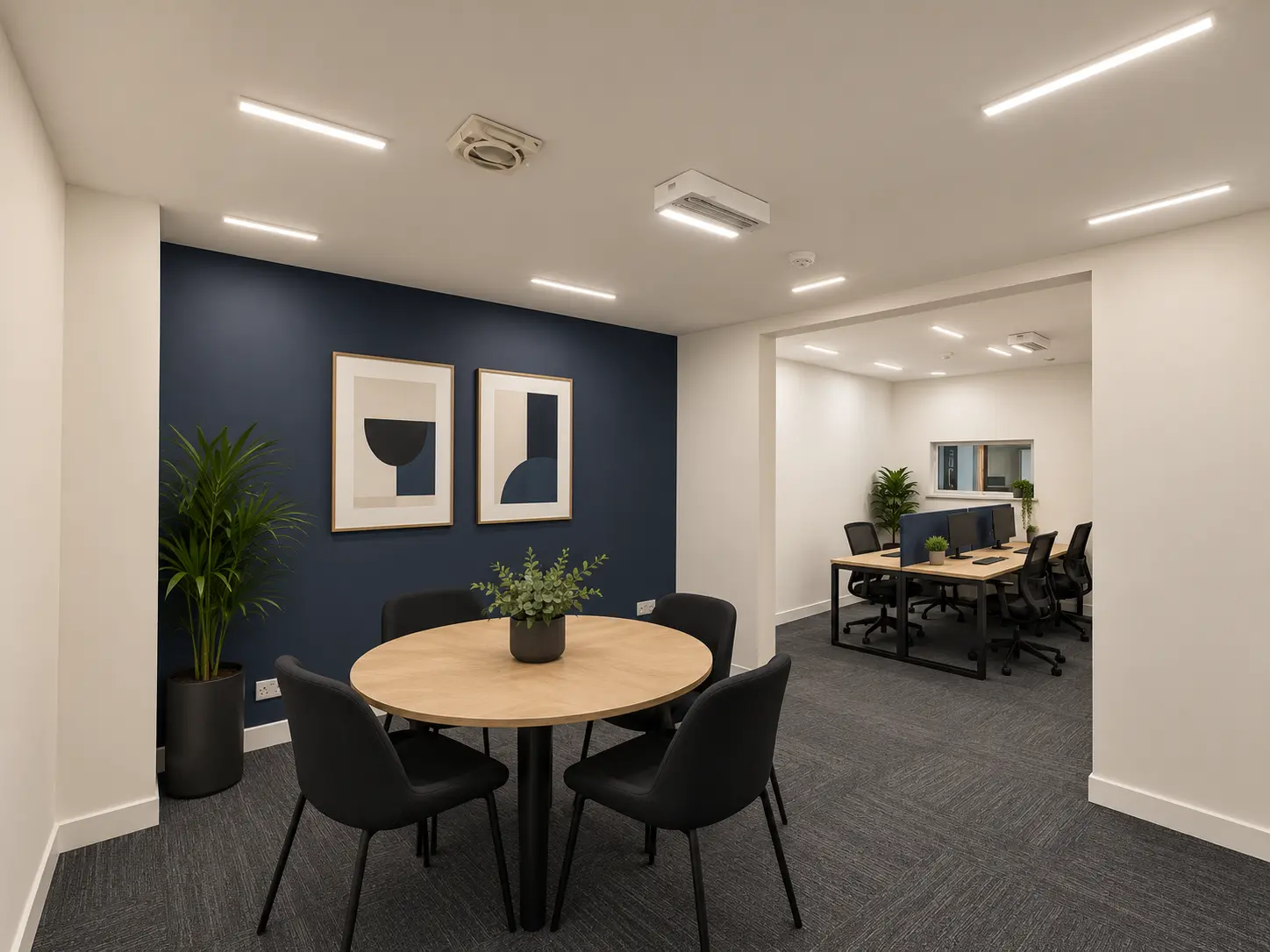 Breakout meeting table leading into an open office at River House
